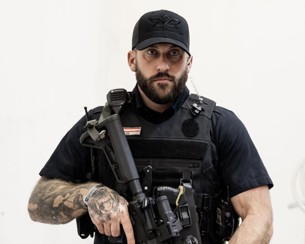 Officer holding rifle in ready stance while wearing the Patrol Carrier 2.0.