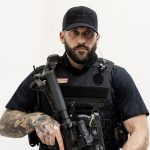 Officer holding rifle in ready stance while wearing the Patrol Carrier 2.0.